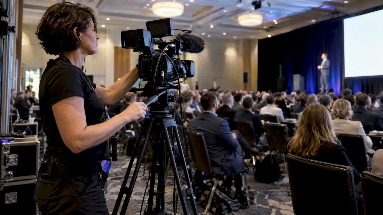 Camera operator filming a corporate keynote